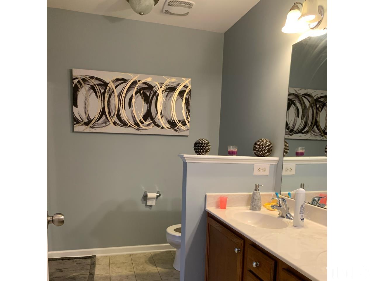1422 Infinity Lane Raleigh, NC 27610 - Photo 15 of 16 a bathroom with a sink and a mirror