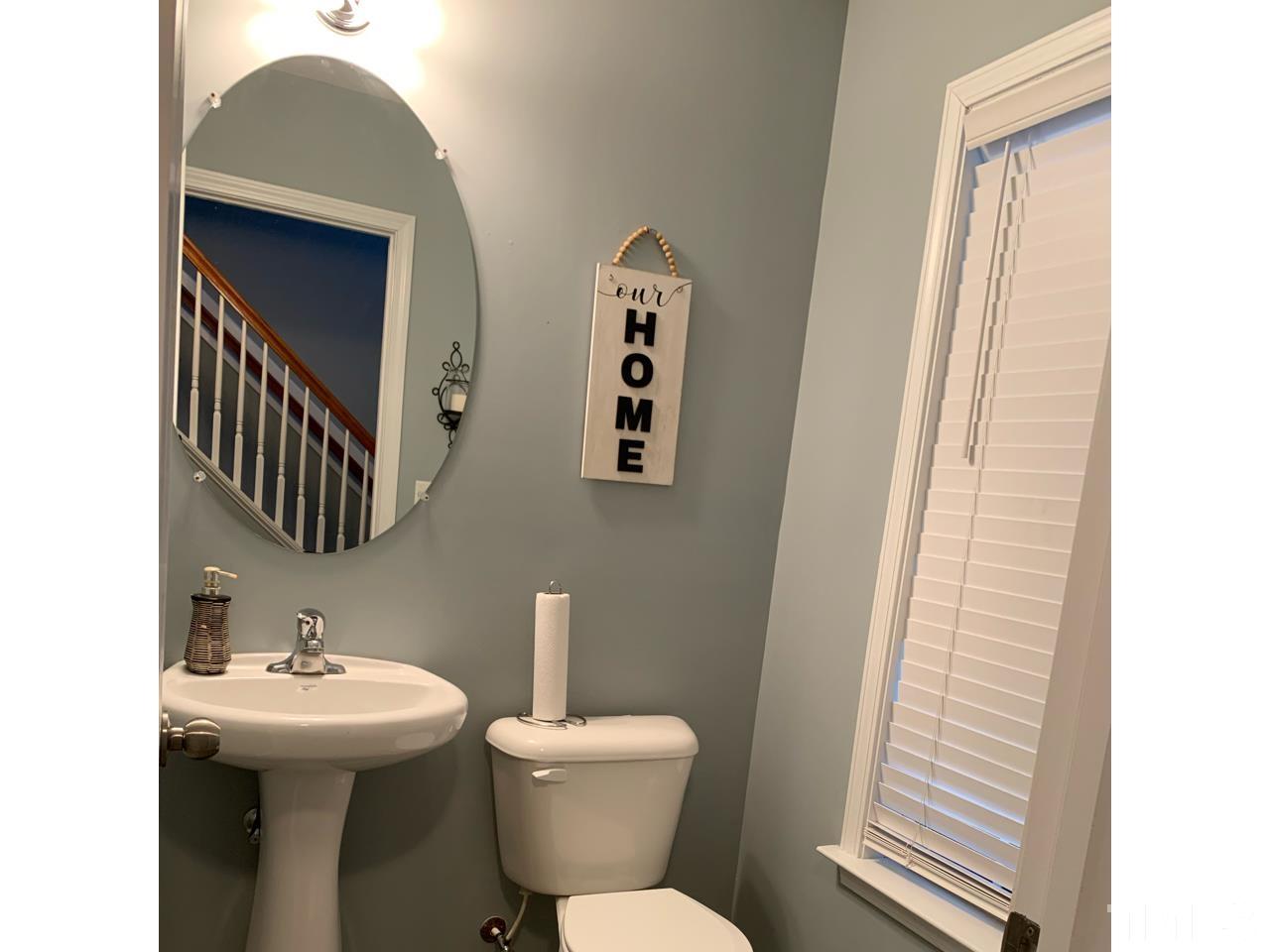 1422 Infinity Lane Raleigh, NC 27610 - Photo 4 of 16 a bathroom with a toilet sink and mirror