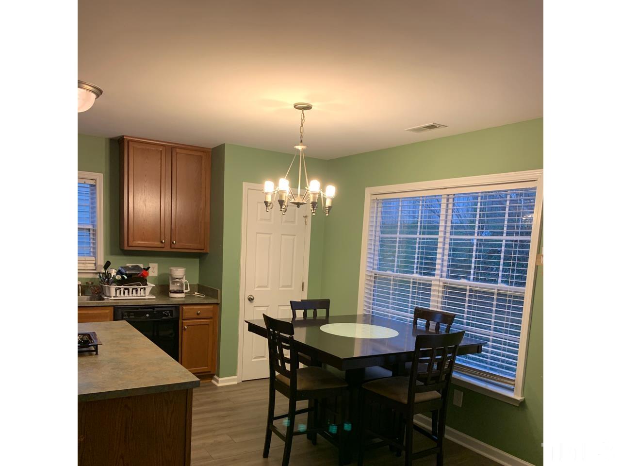 1422 Infinity Lane Raleigh, NC 27610 - Photo 7 of 16 a view of a dining room with furniture and chandelier