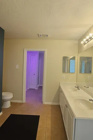 a kitchen with a sink and a toilet