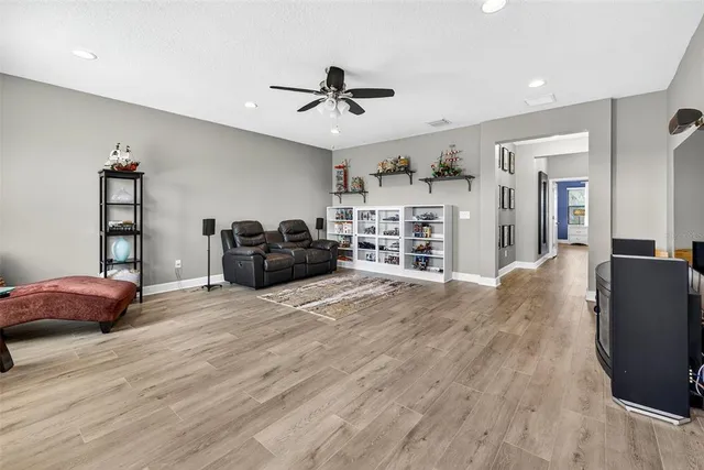 a view of a dining room with furniture a flat screen tv and a floor to ceiling window