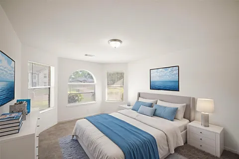 a bedroom with a large bed and a window