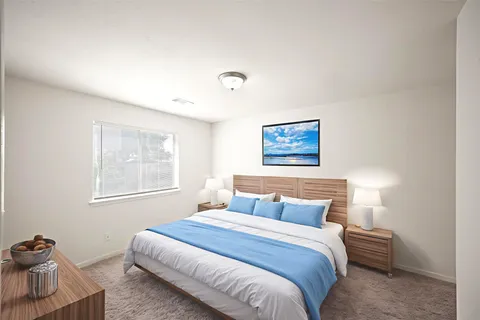 a bedroom with a bed and a window