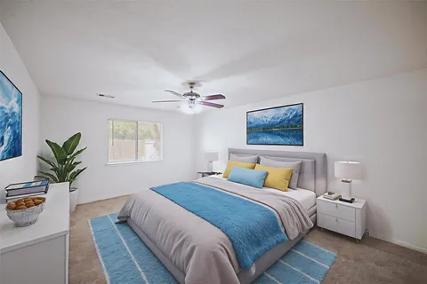 a bedroom with a large bed and a chandelier