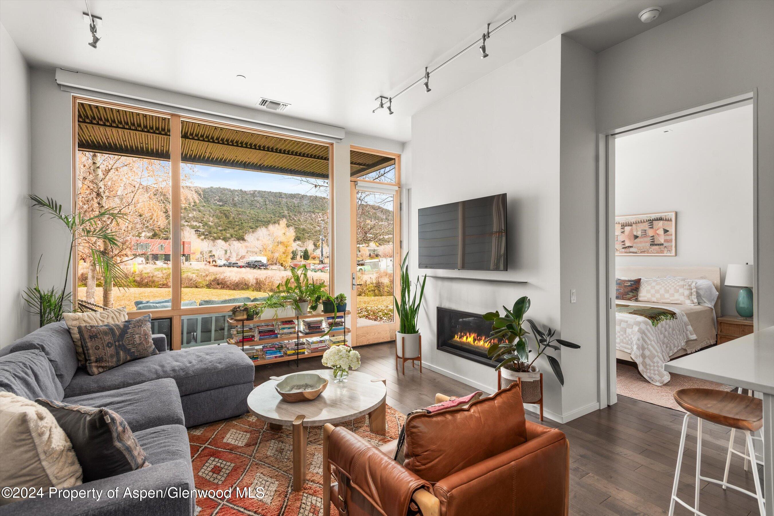 102 Evans Road, Unit 106 Basalt, CO 81621 - Photo 1 of 12 a living room with furniture and a flat screen tv