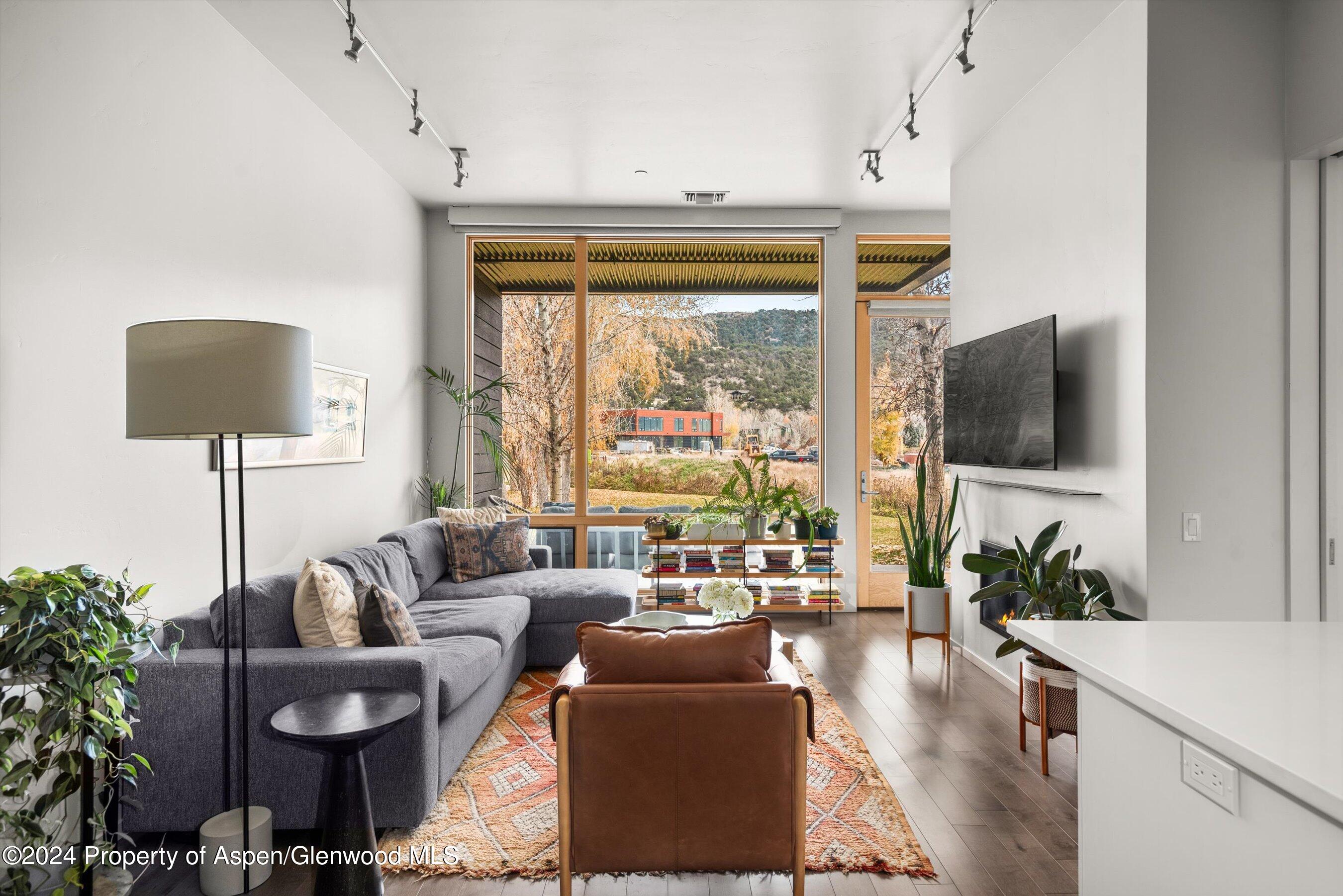 102 Evans Road, Unit 106 Basalt, CO 81621 - Photo 2 of 12 a living room with furniture and a flat screen tv