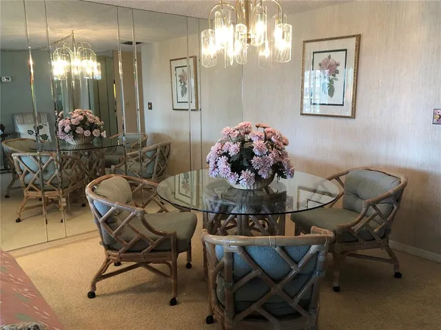 a view of a dining room with furniture and chandelier