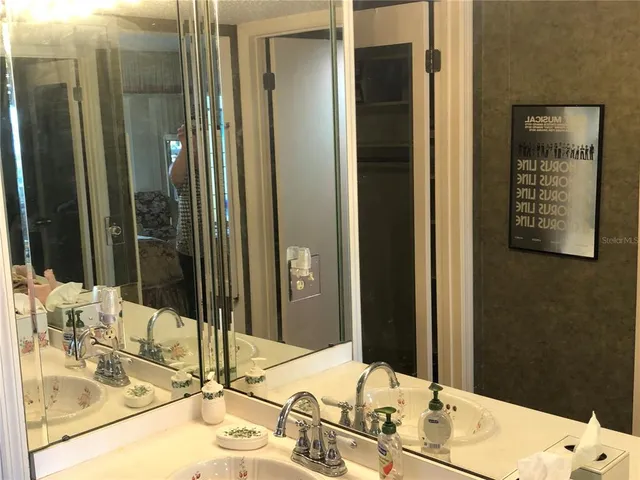a bathroom with a double vanity sink and a mirror