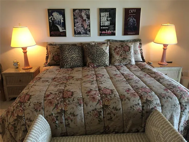 a bedroom with a bed and a lamp