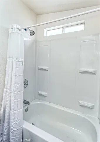 a bathroom with a shower and a bath tub