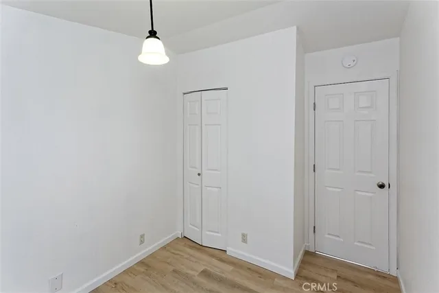 a view of a room with wooden floor and windows