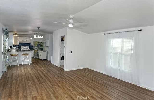 a view of a kitchen with wooden floor and a kitchen