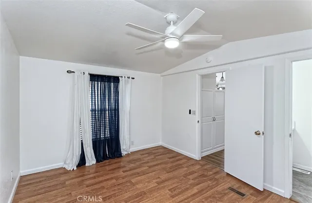 a view of a bedroom with wooden floor