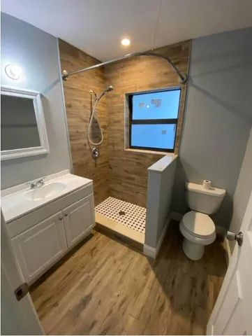 a bathroom with a toilet sink and mirror