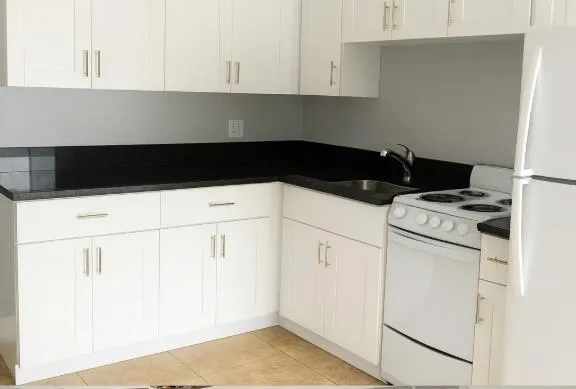 a kitchen with a sink and white cabinets