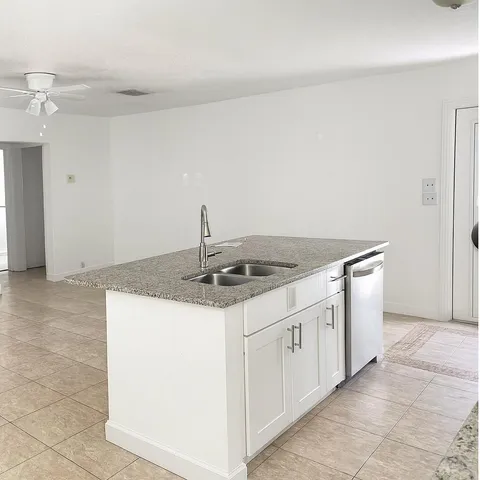 a kitchen that has a sink and a stove