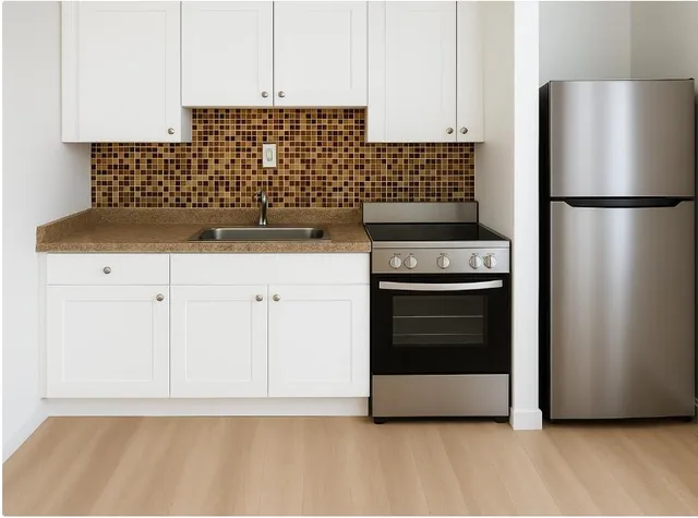 a kitchen with granite countertop a stove and a refrigerator