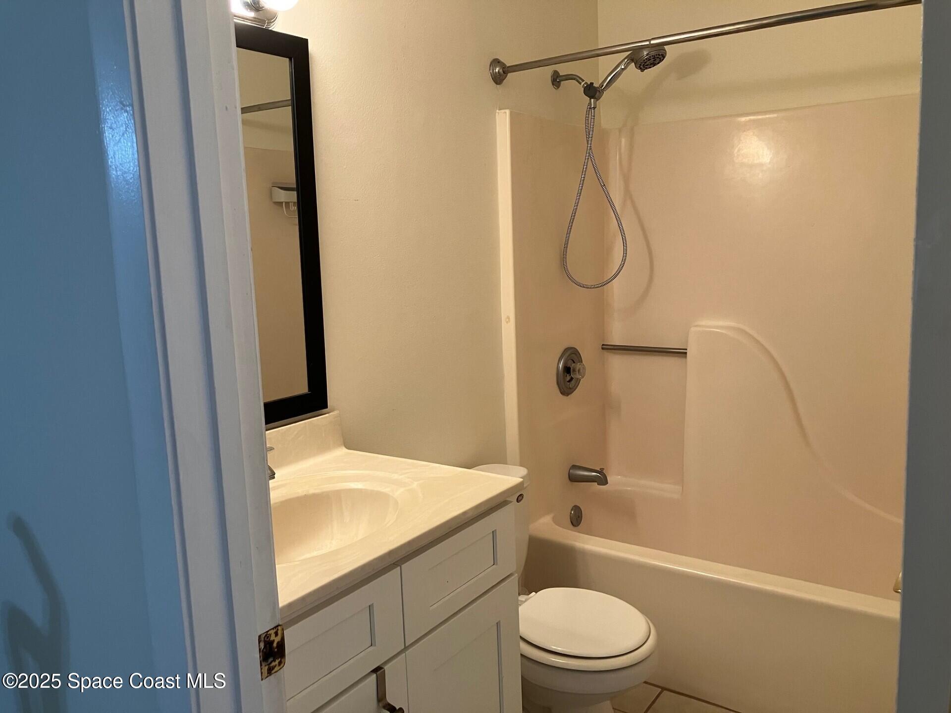 1515 Huntington Lane, Unit 223 Rockledge, FL 32955 - Photo 12 of 15 a bathroom with a granite countertop sink toilet and shower