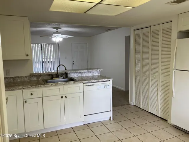 a kitchen with a sink cabinets and appliances