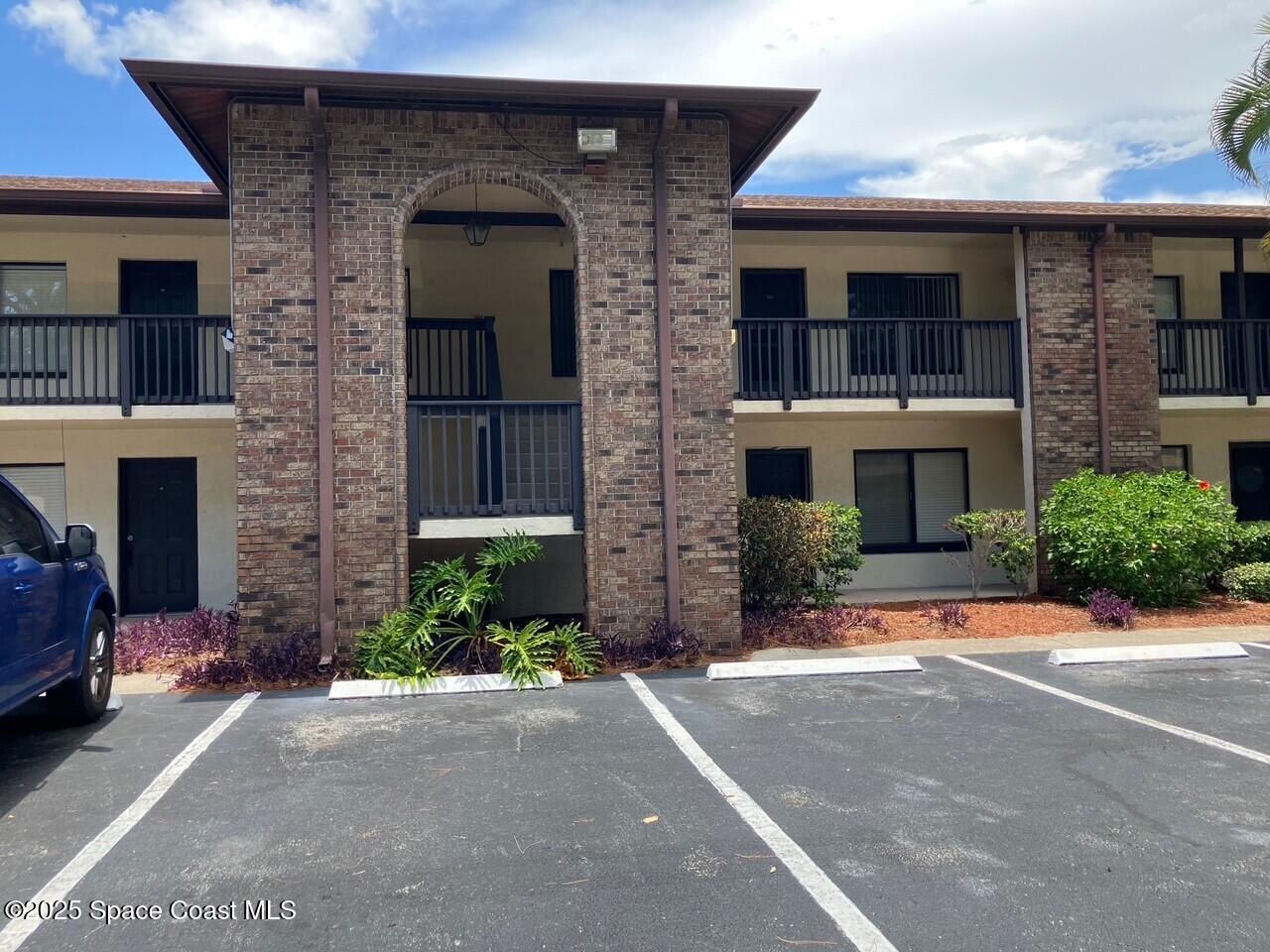 1515 Huntington Lane, Unit 223 Rockledge, FL 32955 - Photo 2 of 15 a front view of a house with a yard