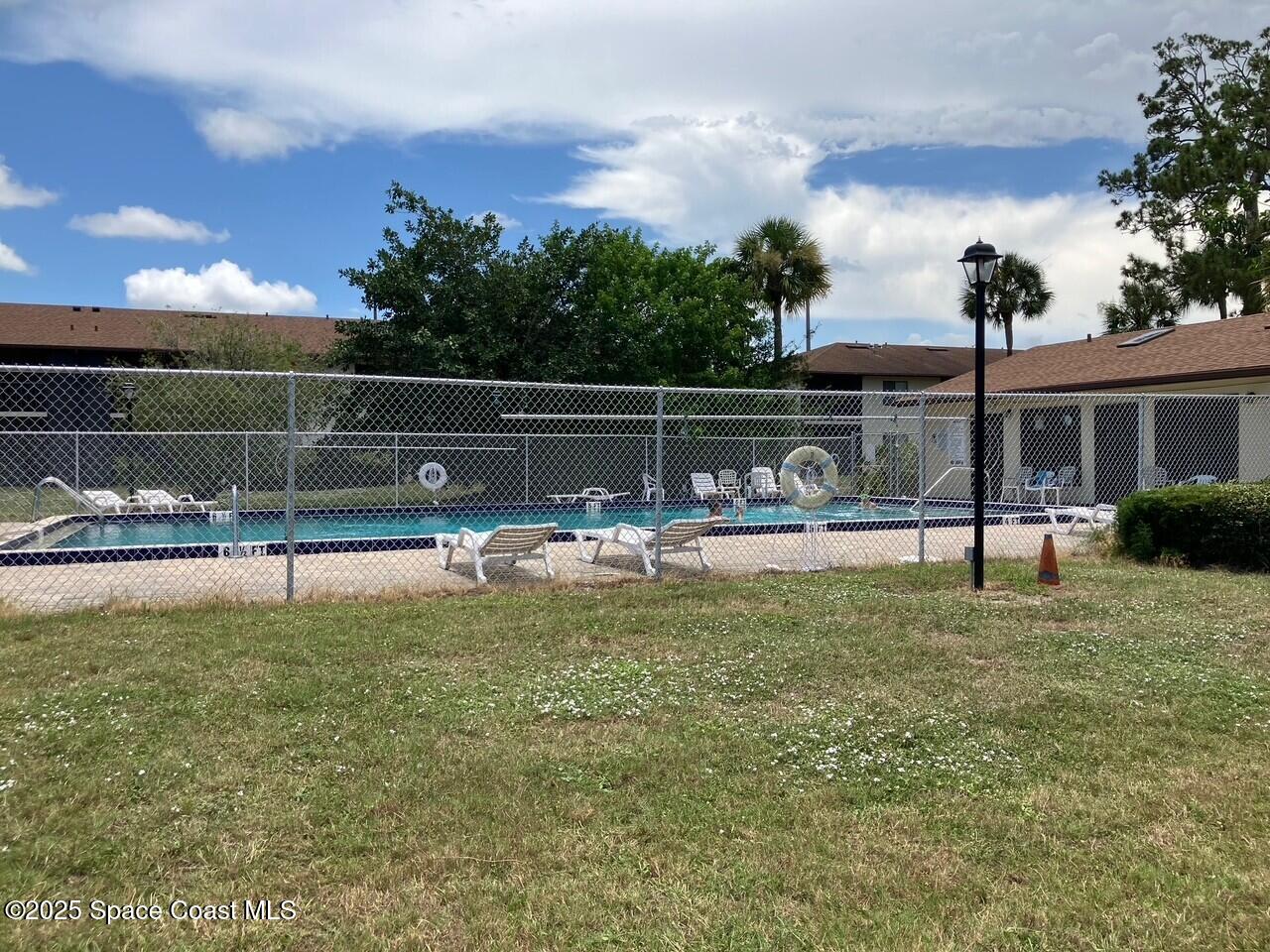 1515 Huntington Lane, Unit 223 Rockledge, FL 32955 - Photo 6 of 15 a view of swimming pool with a yard and sitting area
