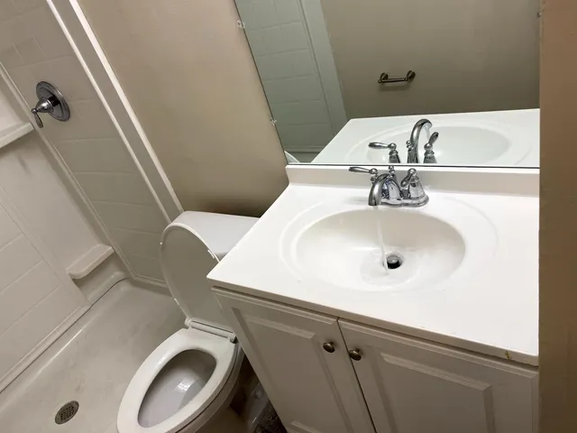 a bathroom with a toilet and a shower