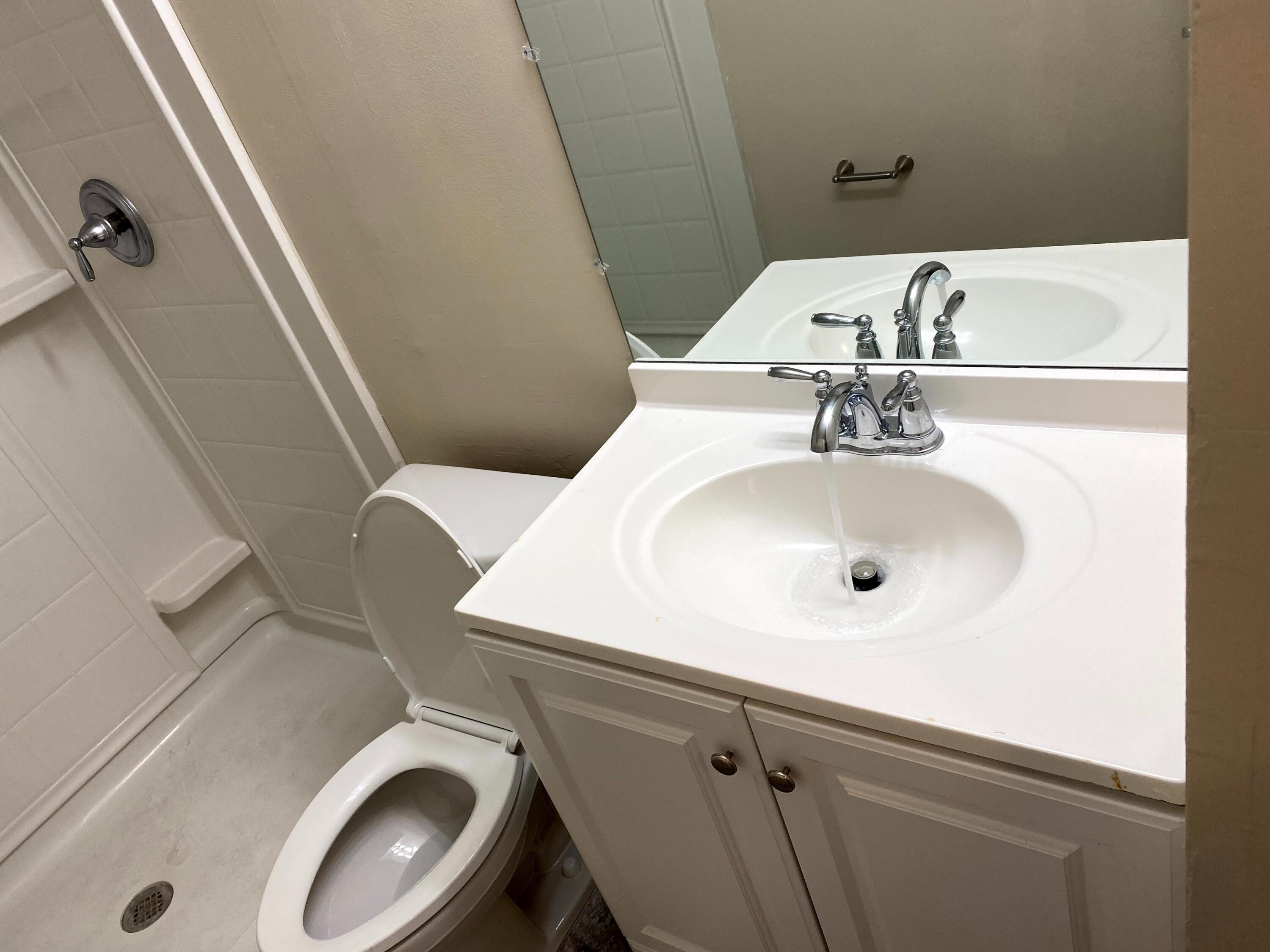 529 14th Street, Unit E West Palm Beach, FL 33401 - Photo 12 of 13 a bathroom with a sink and a toilet