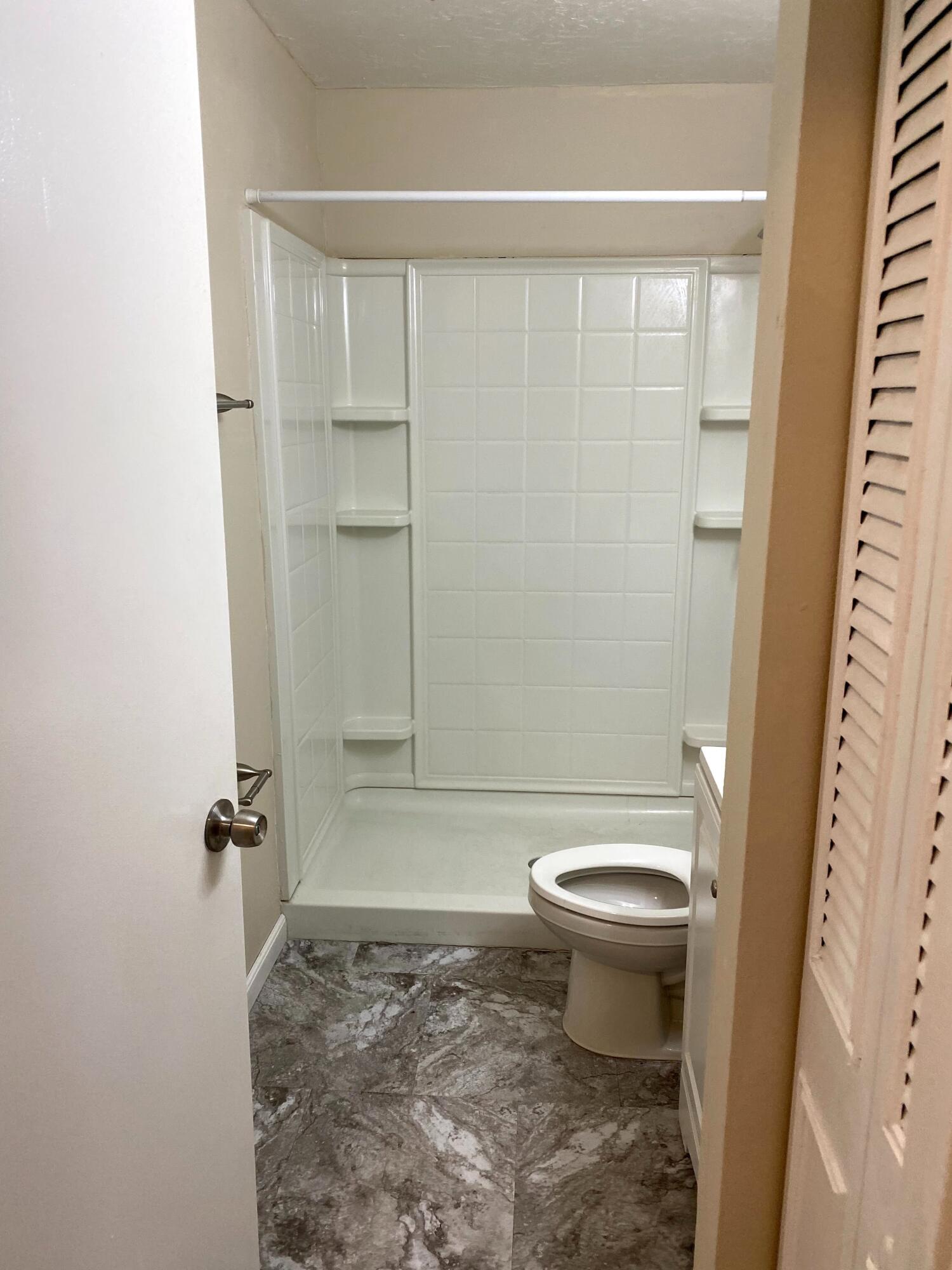 529 14th Street, Unit E West Palm Beach, FL 33401 - Photo 13 of 13 a bathroom with a toilet and a shower