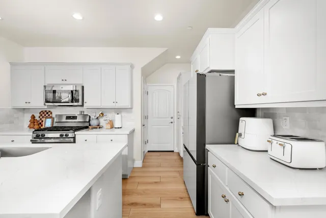 a kitchen with stainless steel appliances a refrigerator stove microwave and sink