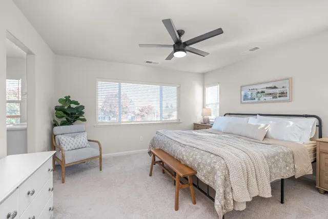 a spacious bedroom with a bed and a window