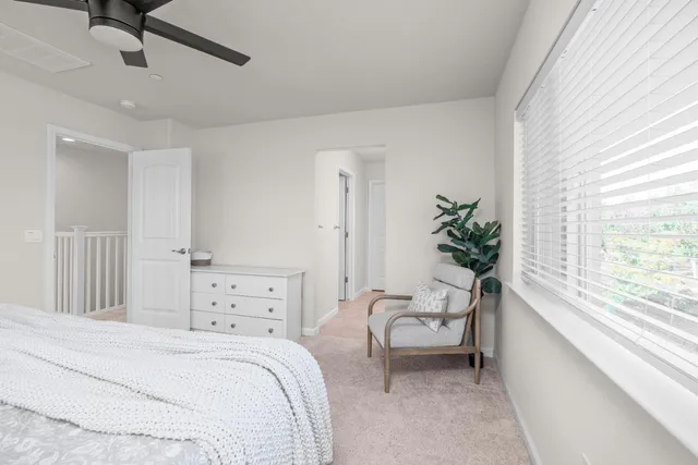 a bedroom with a bed and a chair