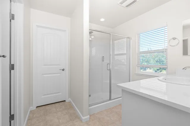 a bathroom with a shower and a sink