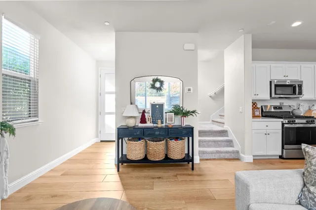 a living room with furniture a fireplace and a large window