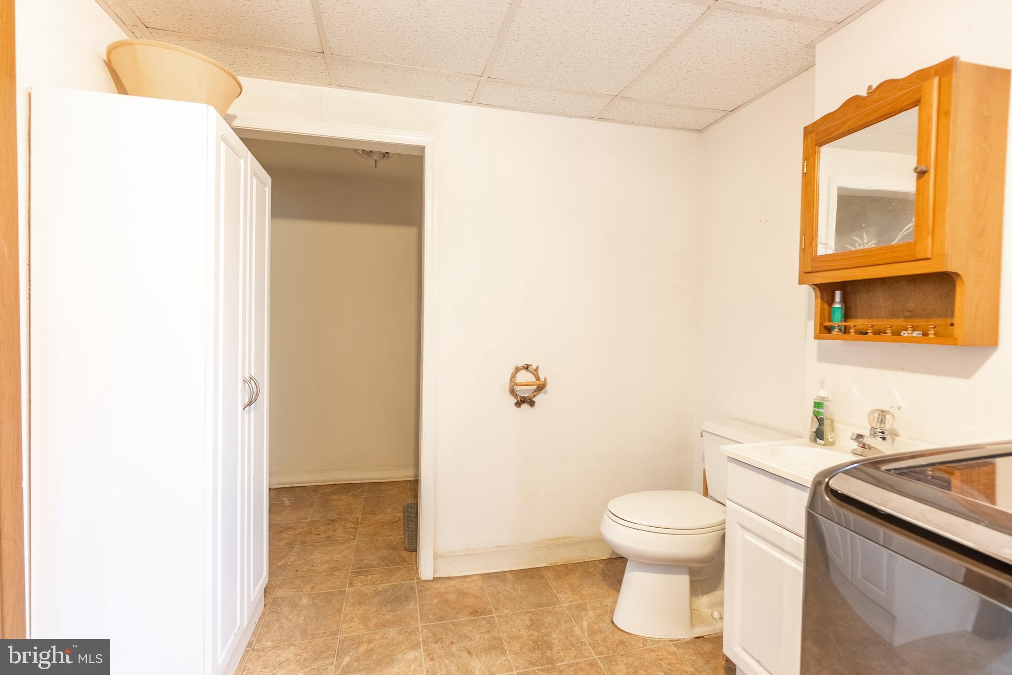 717 East Walnut Street Hanover, PA 17331 - Photo 18 of 21 a white toilet sitting next to a bathroom sink and a mirror