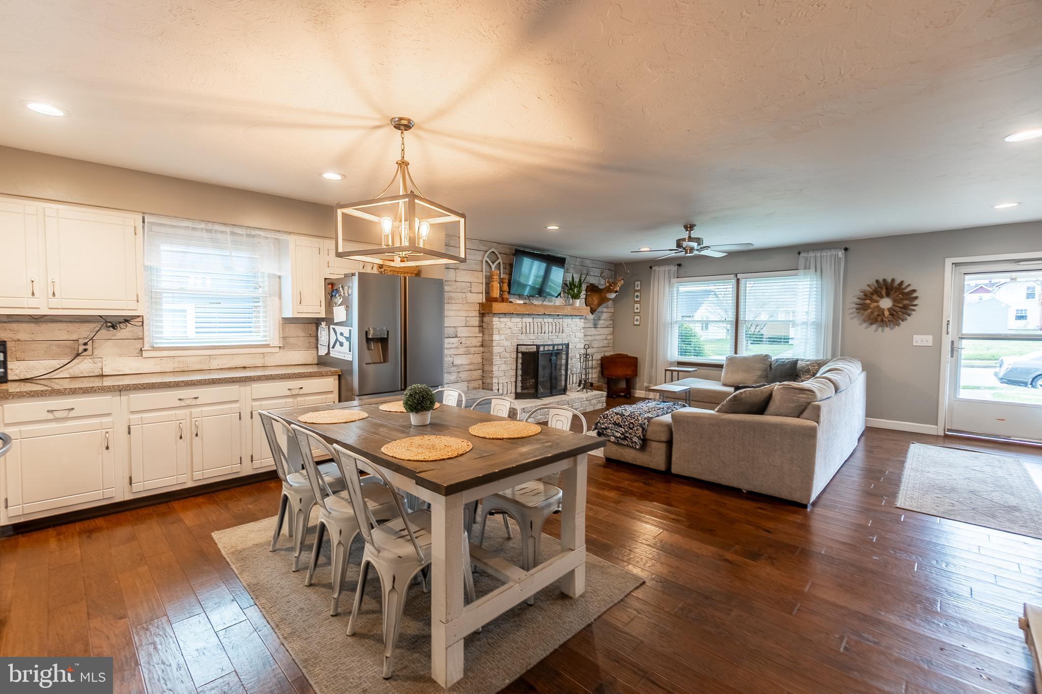 717 East Walnut Street Hanover, PA 17331 - Photo 7 of 21 a kitchen that has a table chairs stove a sink dishwasher and a fireplace with wooden floor
