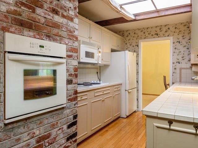 1049 Sycamore Drive Millbrae, CA 94030 - Photo 3 of 19 a kitchen with a stove and a refrigerator