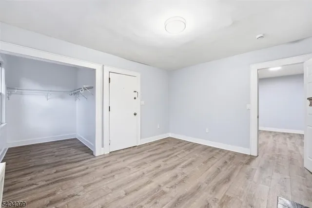 a kitchen with granite countertop white cabinets sink and stainless steel appliances