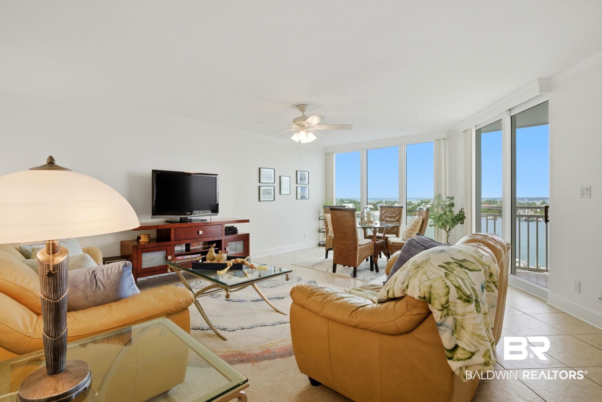 16284 Perdido Key Drive, Unit 912 Perdido Key, FL 32507 - Photo 11 of 49 Living room featuring light tile patterned floors, healthy amount of natural light, ceiling fan, and crown molding