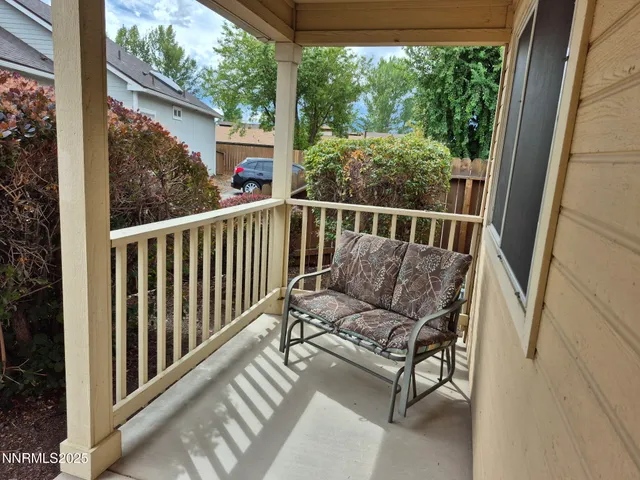 a view of a two chairs in the balcony