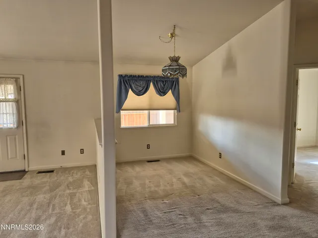 a living room with furniture a window and a flat screen tv