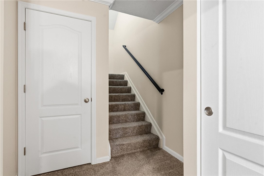 141 Old Pond Road Springboro, OH 45066 - Photo 3 of 20 This interior image shows a carpeted staircase leading to the front door.