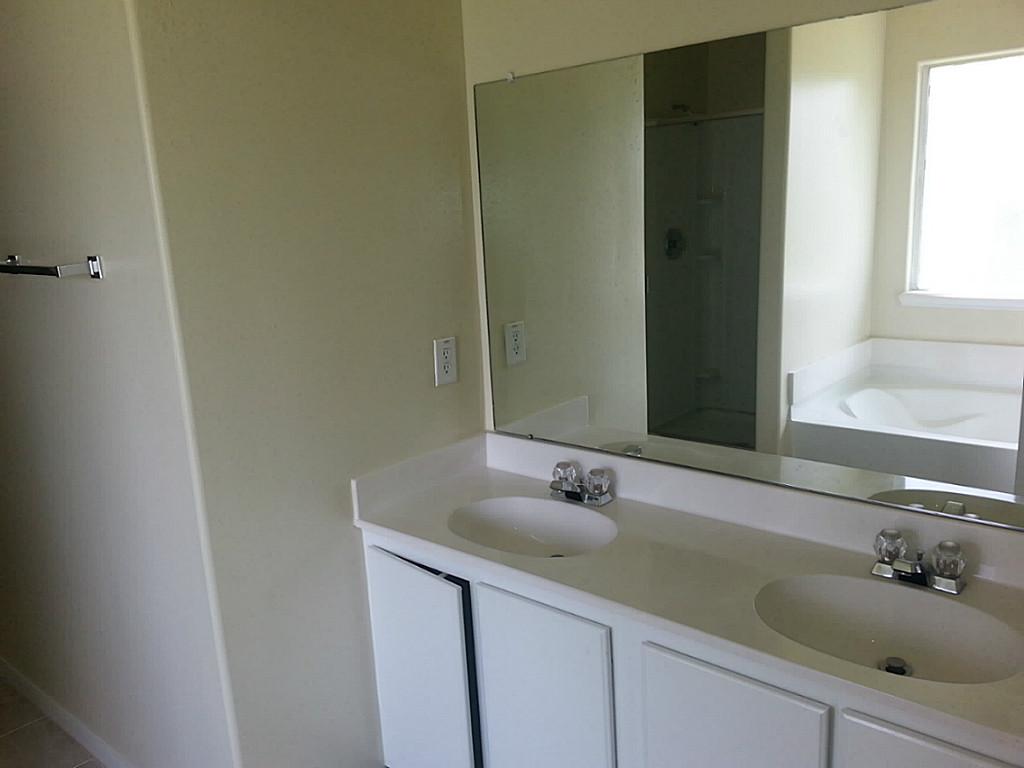 23319 Cape Cottage Court Spring, TX 77373 - Photo 12 of 23 a bathroom with a sink and a mirror