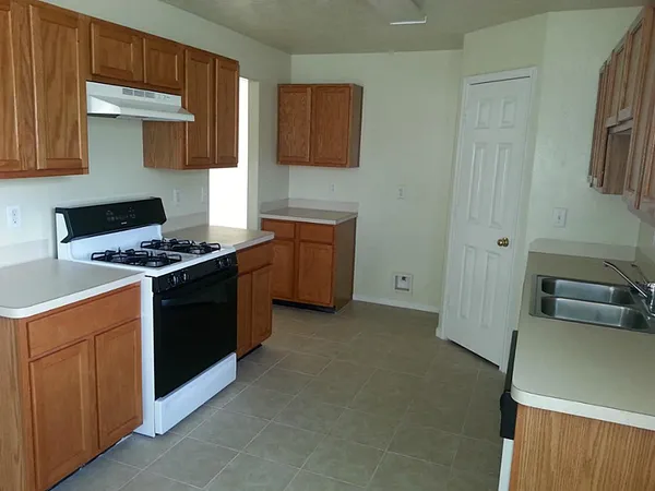 a kitchen with a stove and a refrigerator