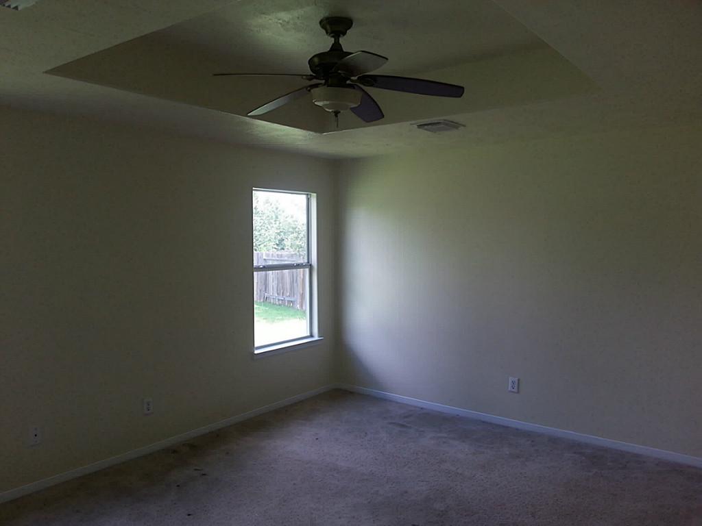 23319 Cape Cottage Court Spring, TX 77373 - Photo 17 of 23 an empty room with a window and a fan