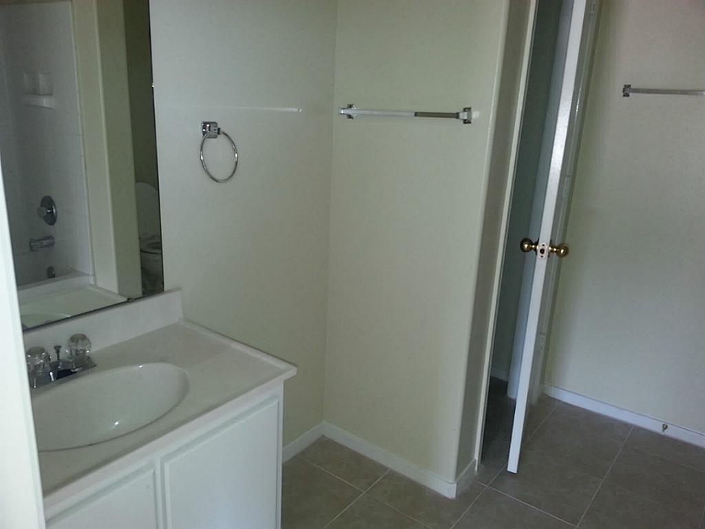23319 Cape Cottage Court Spring, TX 77373 - Photo 21 of 23 a bathroom with a granite countertop sink and a mirror