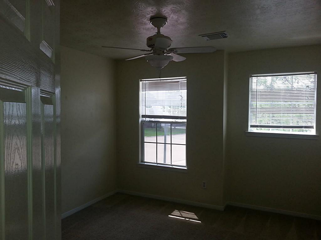 23319 Cape Cottage Court Spring, TX 77373 - Photo 22 of 23 a room with a window and a ceiling fan
