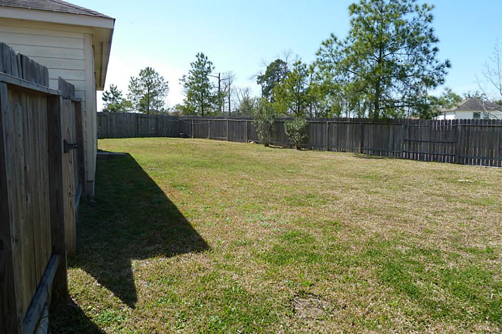 23319 Cape Cottage Court Spring, TX 77373 - Photo 5 of 23 a swimming pool with wooden fence