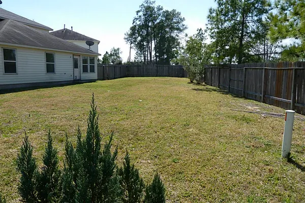 a swimming pool with trees in the background