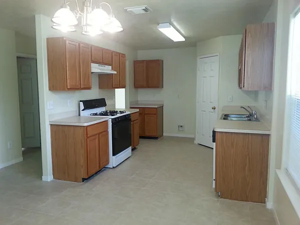 a kitchen with stainless steel appliances a sink stove and cabinets