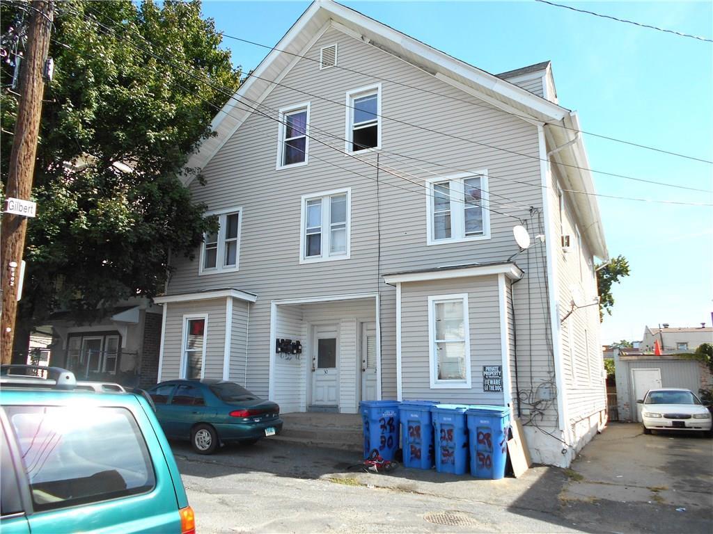 a front view of a house with cars parked